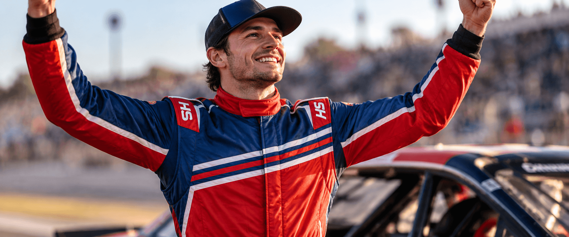 Racer celebrating in a custom HS Race Gear SFI-certified racing suit